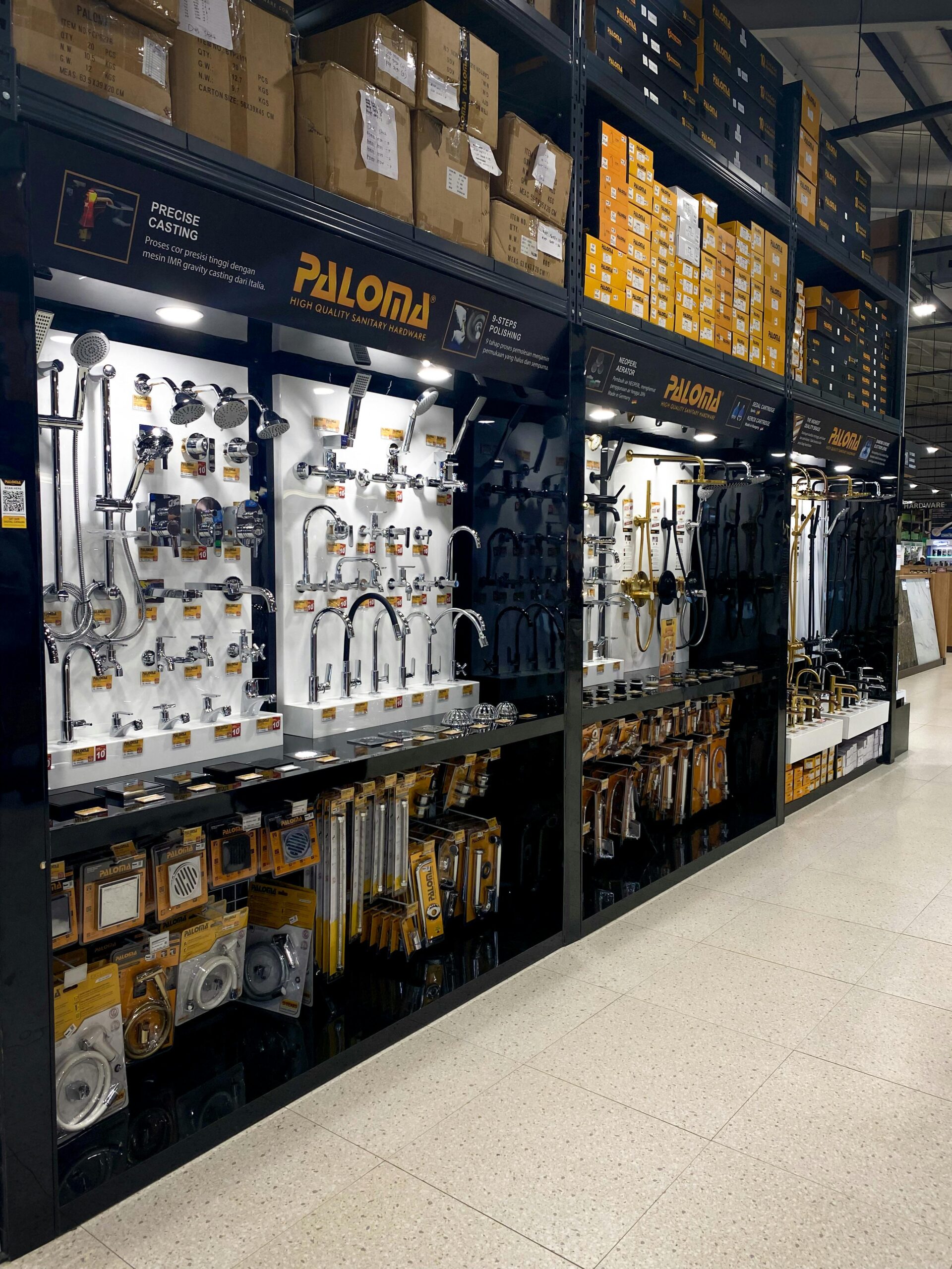 Shelves showcasing a variety of plumbing fixtures, faucets, and tools in a hardware store.
